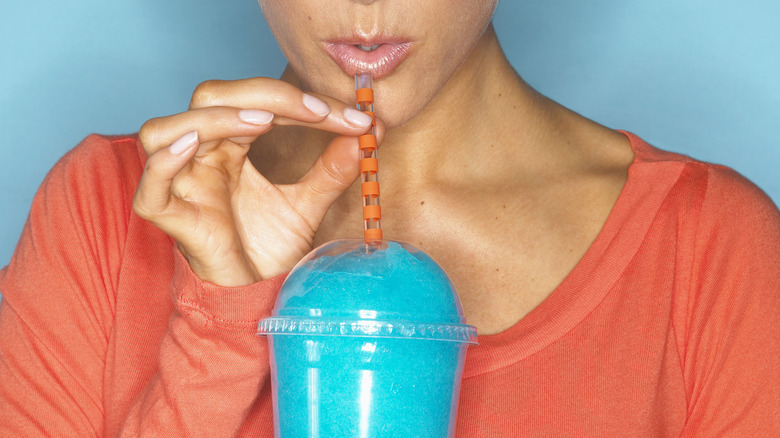 A woman sipping a flavored drink
