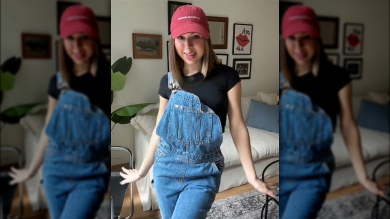 Woman wearing black T-shirt under dungarees