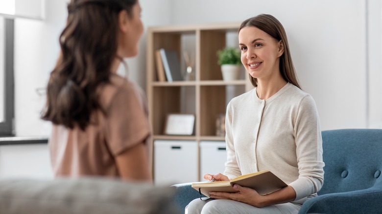 Female therapist talking with female patient