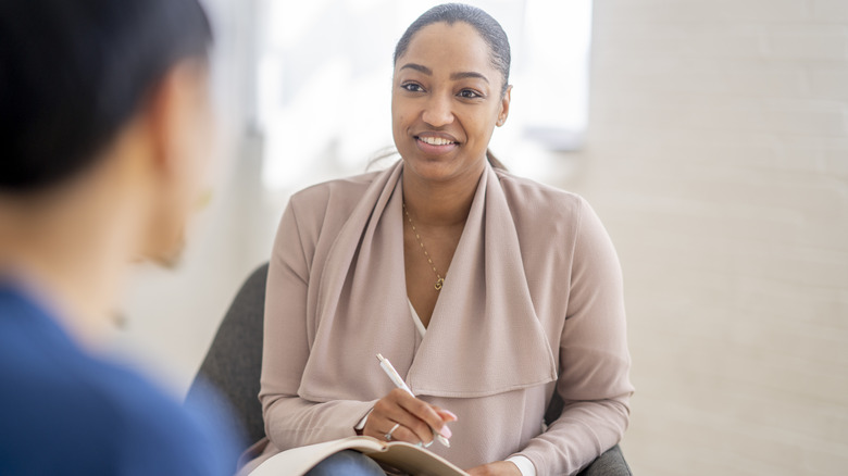 Female therapist talking with patient