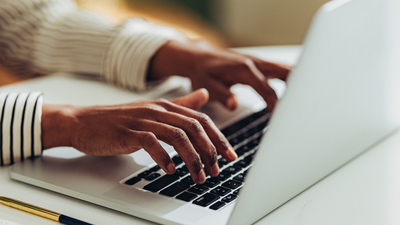 Person typing on keyboard