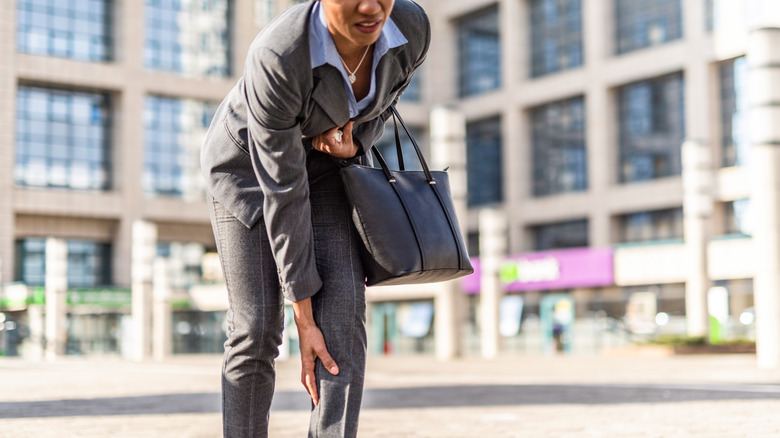 Person in suit with sore knee