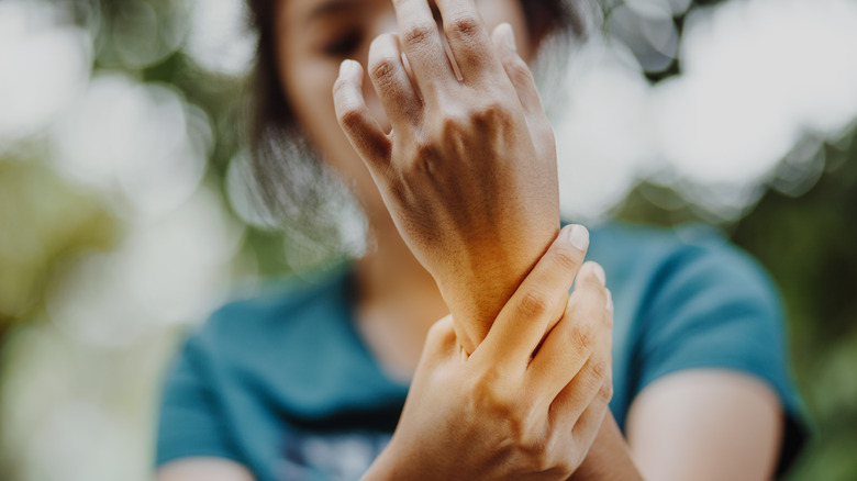 Person holding sore wrist