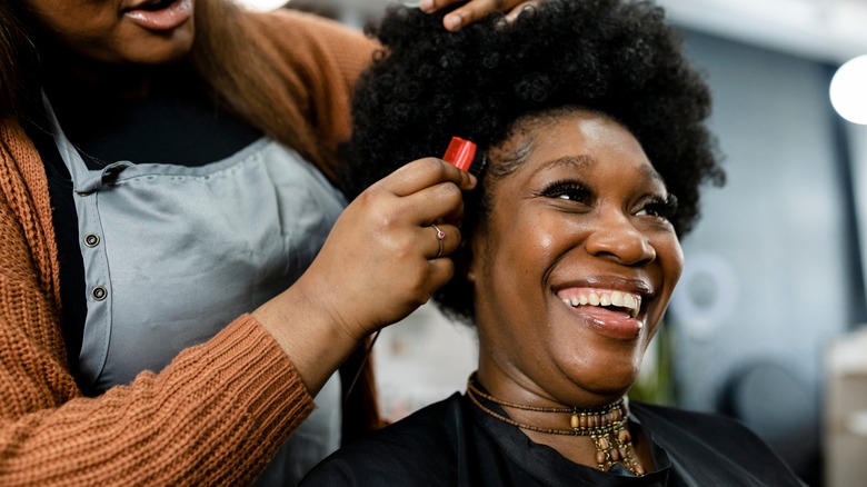 Woman getting hair styled