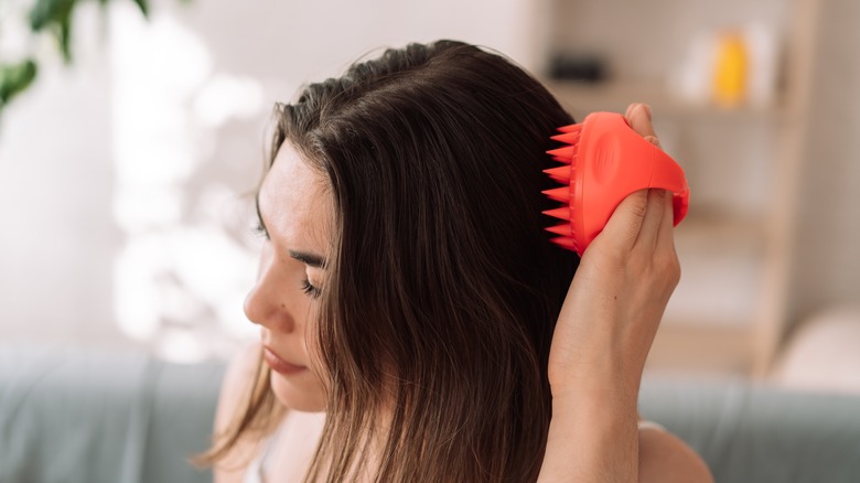 woman using scalp massager