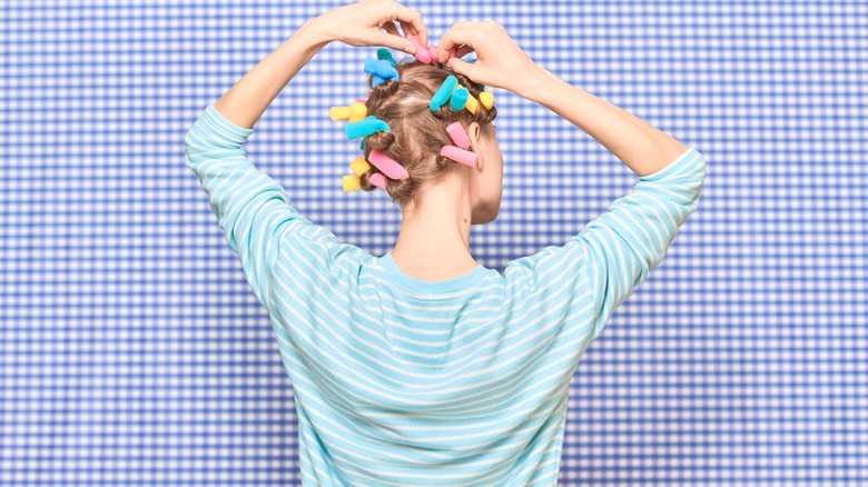 Woman with hair curling rods