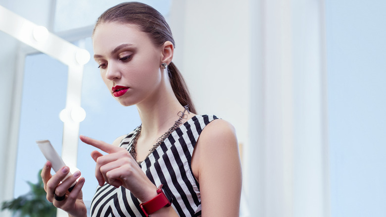Woman studying a product's ingredients list