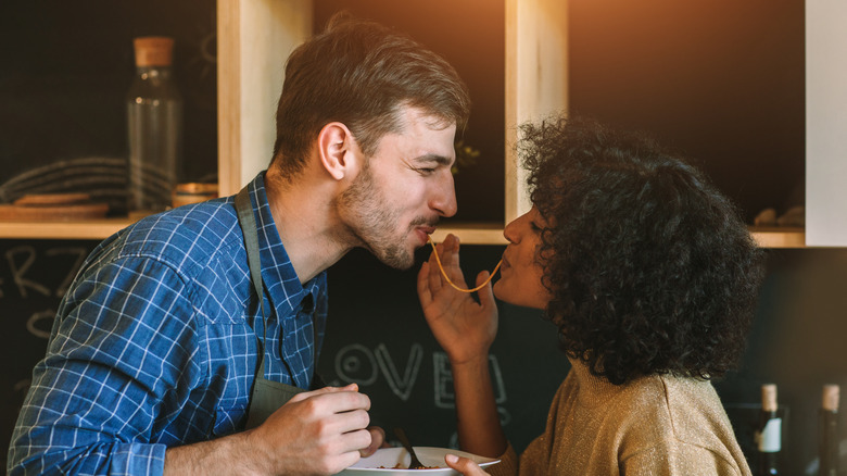 Couple eating a noodle together