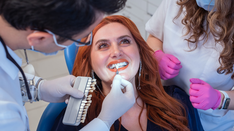 Dentist examining a patient's veneers