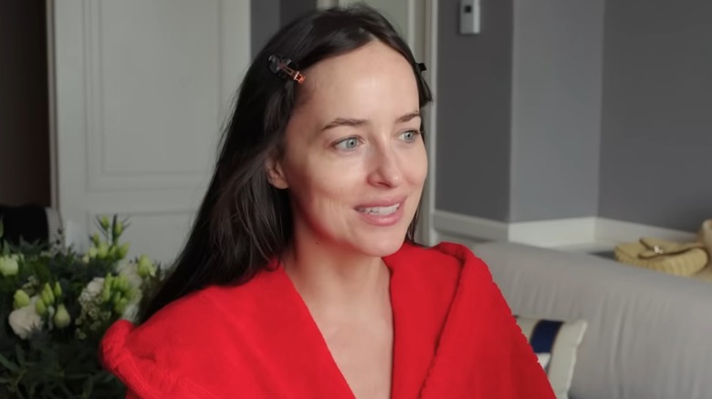 Still of Dakota Johnson wearing no makeup in a hotel room