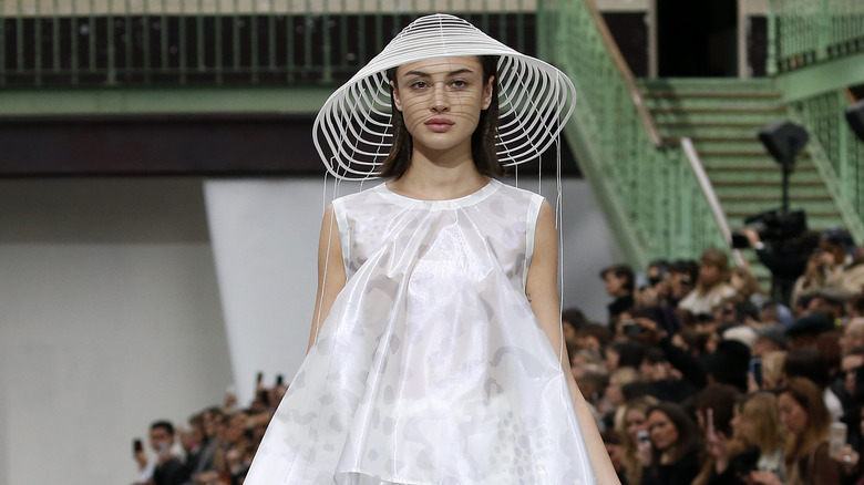 woman walking runway in architectural outfit