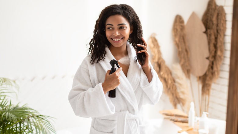 Woman applying leave-in conditioner