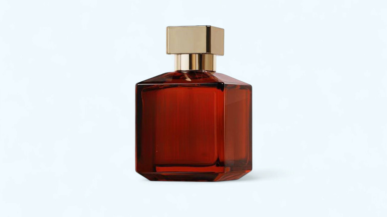 An amber colored bottle of perfume