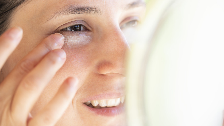 Woman applying eye cream