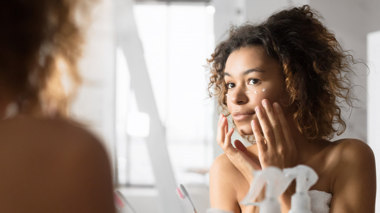 Woman applying eye cream
