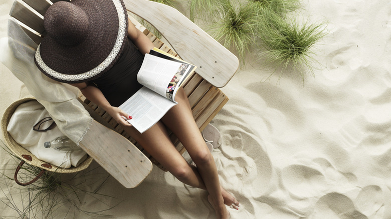 woman relaxes with a book