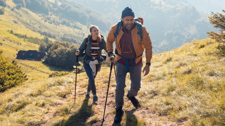A man walking in front of a woman during a hike