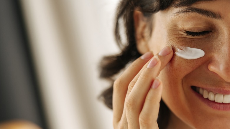 Applying facial moisturizer