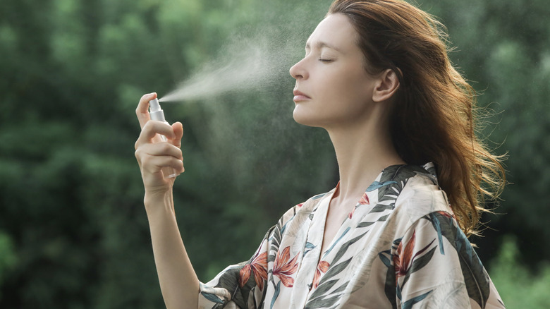 woman sprays face