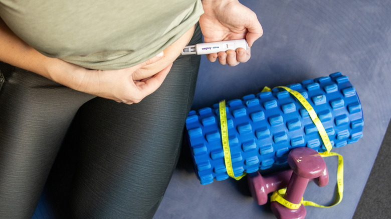 Woman injecting herself with GLP-1