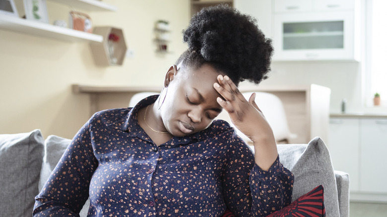 A woman upset on the couch 