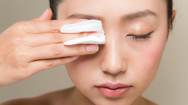 Woman taking off mascara