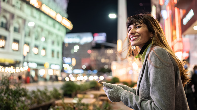 Smiling woman with city backdrop