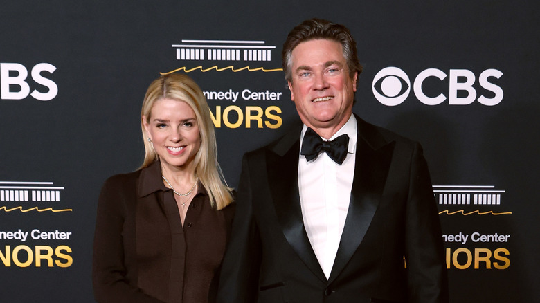 Pam Bondi and John Wakefield smile on the red carpet in 2025