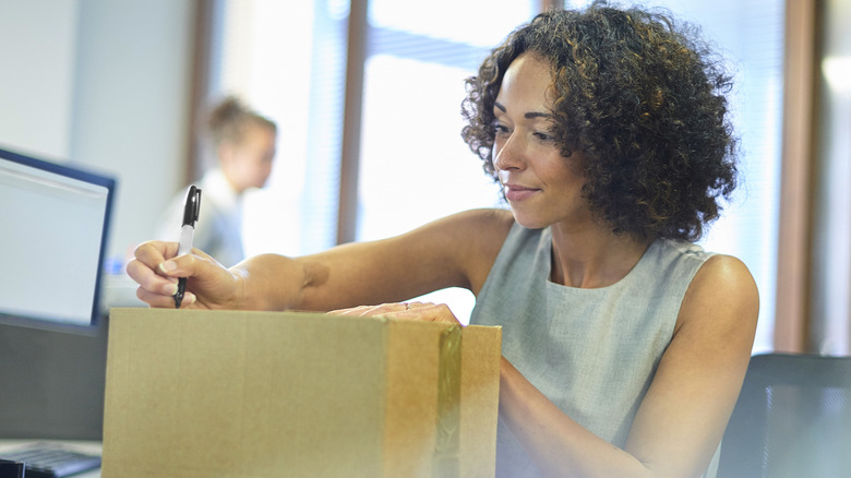 Woman labeling package