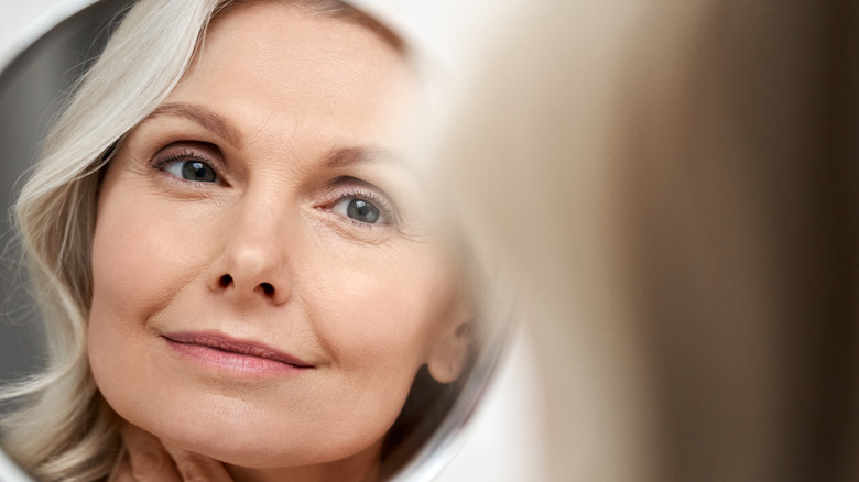 Woman looking at smooth skin