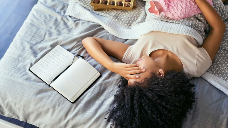 woman rests in bed