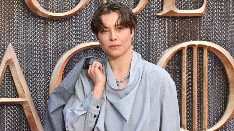 Emma D'Arcy slinging a jacket over her shoulder