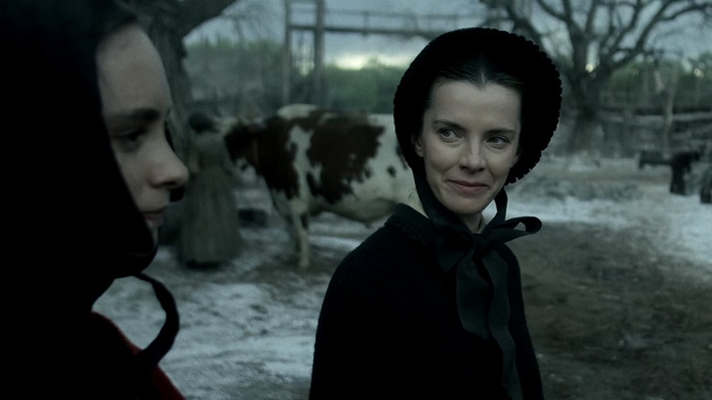 Still of Betty Gilpin looking over at Saura Lightfoot-Leon in "American Primeval"
