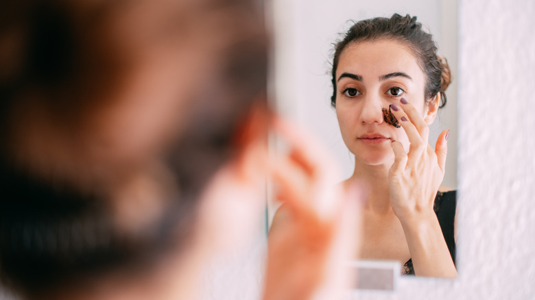 Woman exfoliating her skin