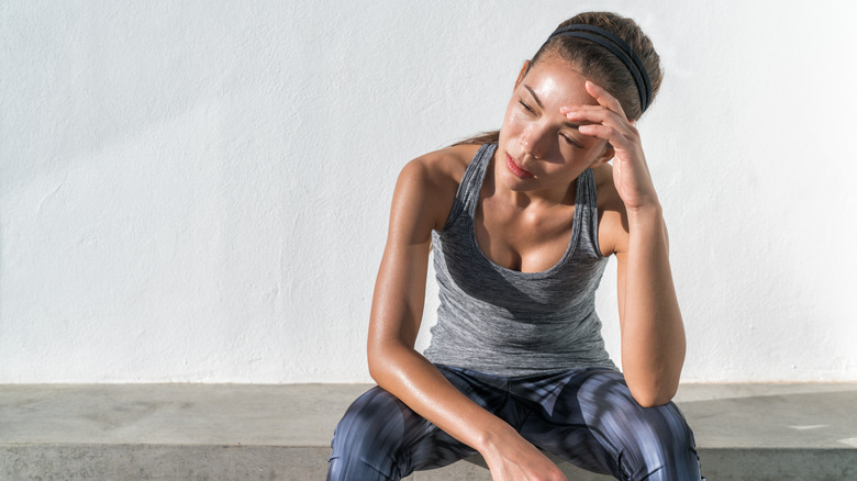 Frustrated woman in gym clothes