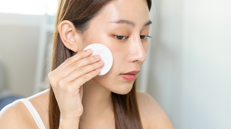 Woman applying toner 