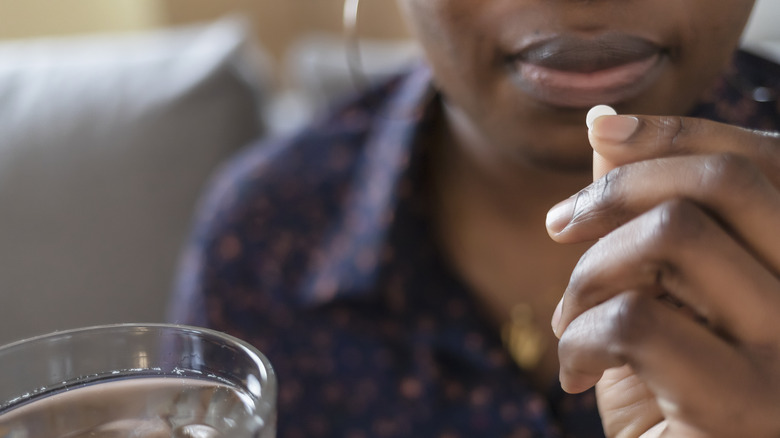 woman taking pill