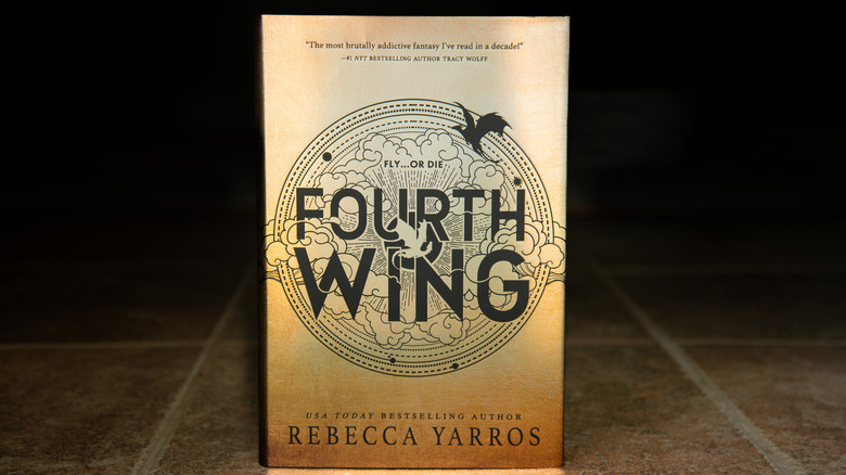 Fourth Wing book standing on a floor