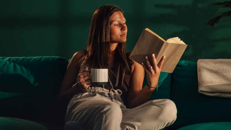 Woman reading book on a couch