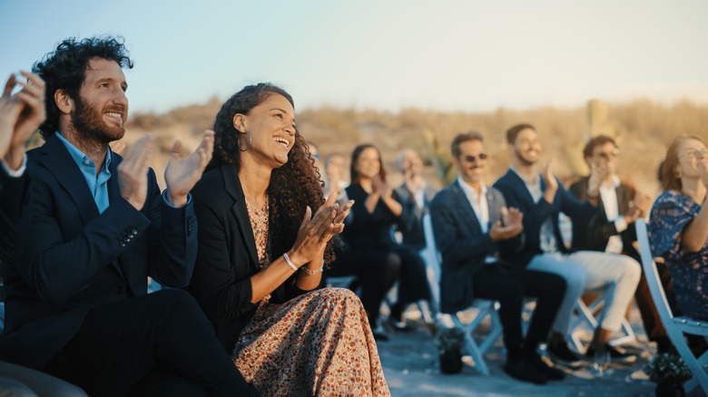 People clapping at a wedding 