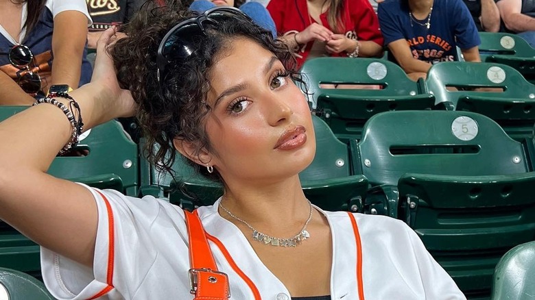 woman seated in stadium chair