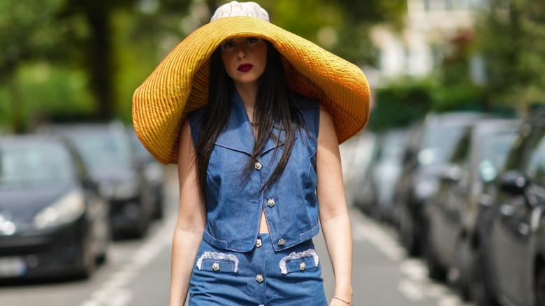 Woman walking in a giant sunhat