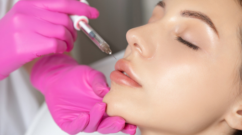 Woman receiving lip flip treatment