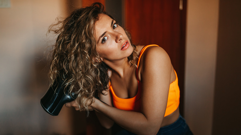 woman dries her hair