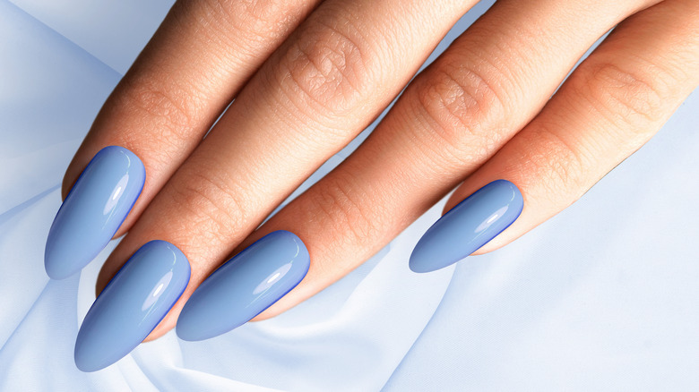 manicured nails with blue polish 