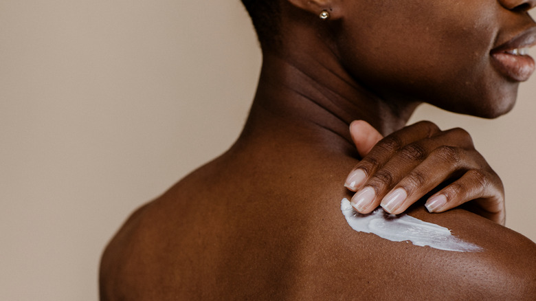 Woman applying lotion