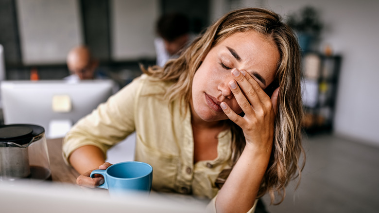 Woman looks anxious at work