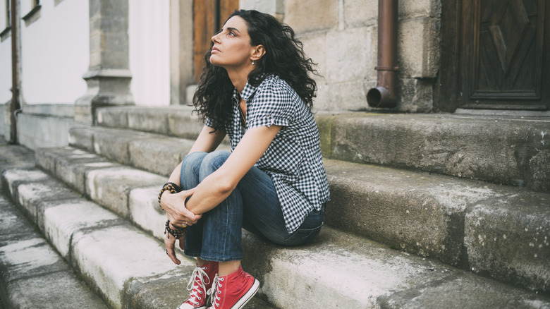 Woman sitting on front stoop