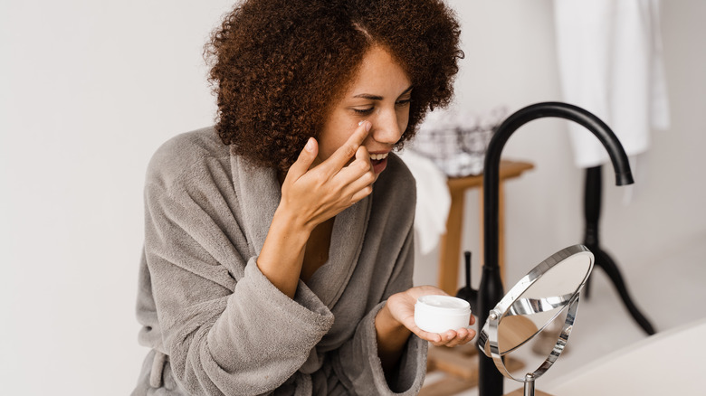 Applying eye cream