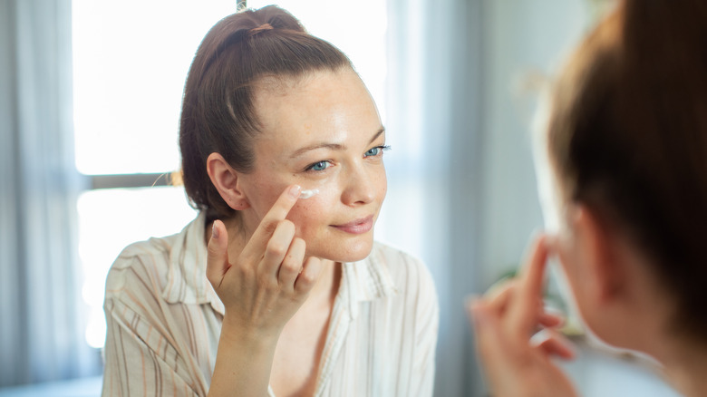 Applying eye cream